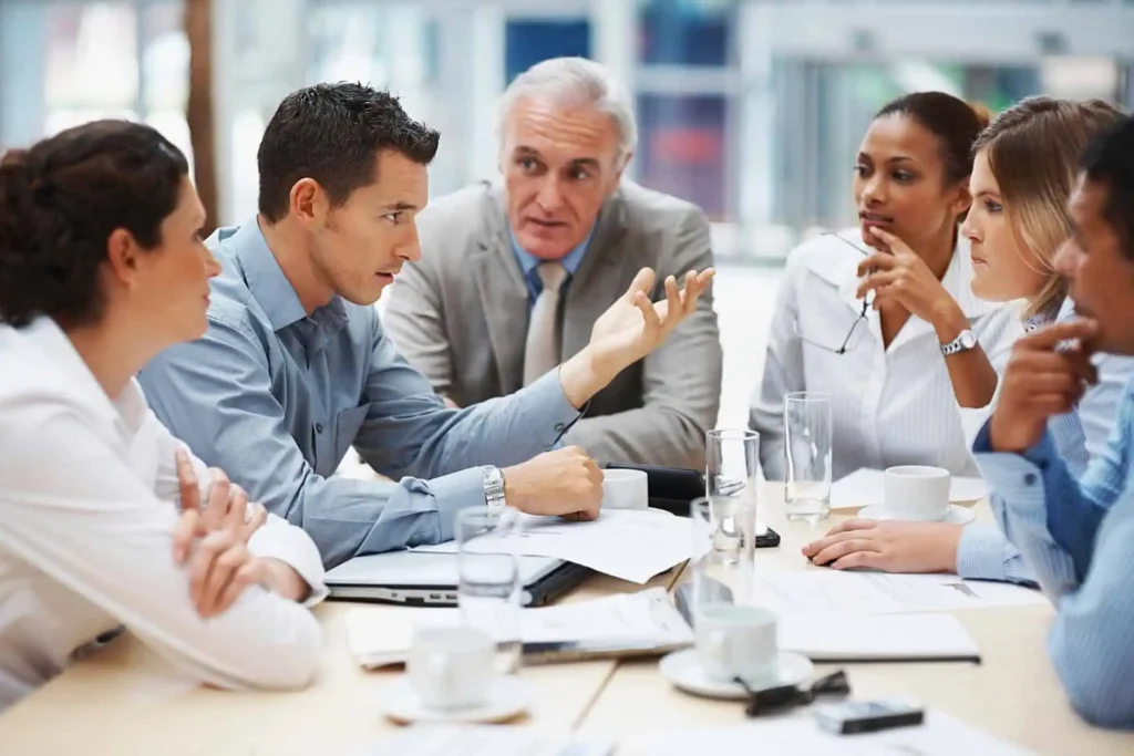 Manager presenting documents to team in conference room